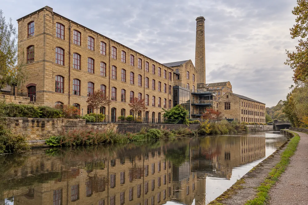 Yorkshire stone mill buildings beside a canal towpath